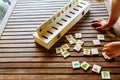 Child having fun with an educational wooden game at school, to make pairs, useful to improve the memory and dexterity of their