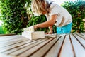 Child having fun with an educational wooden game at school, to make pairs, useful to improve the memory and dexterity of their