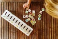 Child having fun with an educational wooden game at school, to make pairs, useful to improve the memory and dexterity of their