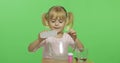 Child having fun making slime. Pour the glue. Kid with hand made toy