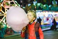 Child having a great time eating a candy floss at a night fair Royalty Free Stock Photo