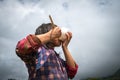 A child having lunch with bowl and chopstick on rice field in Asia. Concept of poverty, food crisis, children right.