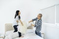 Child having pillow fight with her father at home Royalty Free Stock Photo