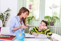 Child having problem with concentration while doing homework. Stressed Mother and Son Frustrated Over Failure Homework, School Royalty Free Stock Photo