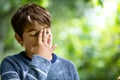 Child with headache. Upset young boy outdoors Royalty Free Stock Photo