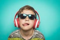 Child with headphones of music and funny expression