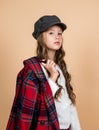 child in headwear and checkered jacket, retro trend