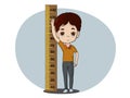 Cute boy Happily measuring his height Royalty Free Stock Photo