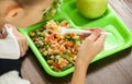 Child with healthy food for school lunch at desk