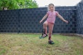 The child helps with scarifying the lawn. Royalty Free Stock Photo