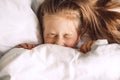 Child hiding under duvet in bed Royalty Free Stock Photo