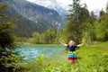 Child hiking in flower field at mountain lake Royalty Free Stock Photo