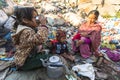 Child and his parents during lunch in break between working on dump.