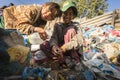 Child and his parents during lunch in break between working on dump. Royalty Free Stock Photo