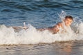 Child hit by a sea wave Royalty Free Stock Photo