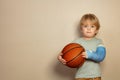 Child hold basketball ball with broken hand in plaster cast Royalty Free Stock Photo