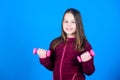 Child hold little dumbbell blue background. Sport for teens. Easy exercises with dumbbell. Toward stronger body Royalty Free Stock Photo