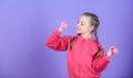 Child hold little dumbbell violet background. Beginner dumbbell exercises. Sport for teens. Easy exercises with dumbbell Royalty Free Stock Photo