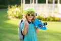 Child hold skateboard on a sunny day in the park. Outdoor portrait of little skateboarder. Concept of activity and happy