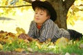 Child holding autumn leaves