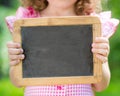 Child holding blackboard