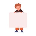 Child holding blank banner, paper sheet in hands. Happy smiling boy kid standing, showing empty clean placard for Royalty Free Stock Photo