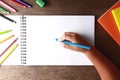 A child holding a blue pencil drawing on a white paper. Royalty Free Stock Photo