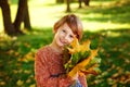 The child is holding a bouquet of maple leaves in his hands. A happy child, a little boy playing in a beautiful autumn park on a Royalty Free Stock Photo