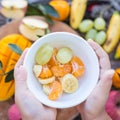 Child holding a bowl of fruit Royalty Free Stock Photo