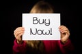 Child holding Buy Now sign Royalty Free Stock Photo