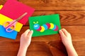 Child holding a caterpillar card. Summer paper crafts Royalty Free Stock Photo