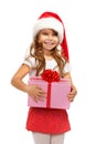 Child holding Christmas gift box in hand. on background Royalty Free Stock Photo