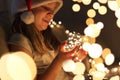 Child holding Christmas lights