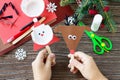 A child is holding Christmas Santa and Reindeer stics puppets. Handmade. Royalty Free Stock Photo