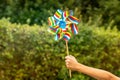 Child holding colorful pinwheel