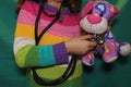 A child holding a dog toy. a young girl wants to become a veterinarian, vet