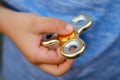 Child holding fidget, finger spinner