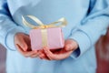 Child Holding a Gift Box On a Blue Background