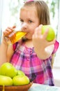 Child holding green apple and drinking juice Royalty Free Stock Photo