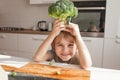 Child holding green broccoli.  Healthy  food concept. Child nutrition. Fresh vegetables in the hands of a cheerful boy child Royalty Free Stock Photo