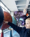 Child holding hand on globe. A child hand on a large model of the planet earth. The concept of protecting the environment, caring Royalty Free Stock Photo