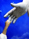 Child Holding Hand of Jesus Statue Royalty Free Stock Photo