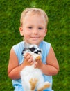 Child holding on hands of a small rabbit