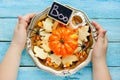 Child holding in hands traditional halloween treats in bowl