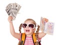 Child holding international passport and money.