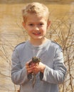 Child holding a large bullfrog Royalty Free Stock Photo