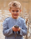 Child holding a large bullfrog Royalty Free Stock Photo