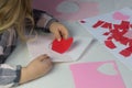 Child holding letter with red paper heart,love letter for Valentine& x27;s day,gift for Mothers day,little girl put