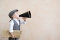 Child shouting through vintage megaphone