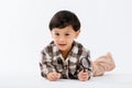 Child holding magnifying glass on white background. Boy with a magnifying glass in studio. Royalty Free Stock Photo